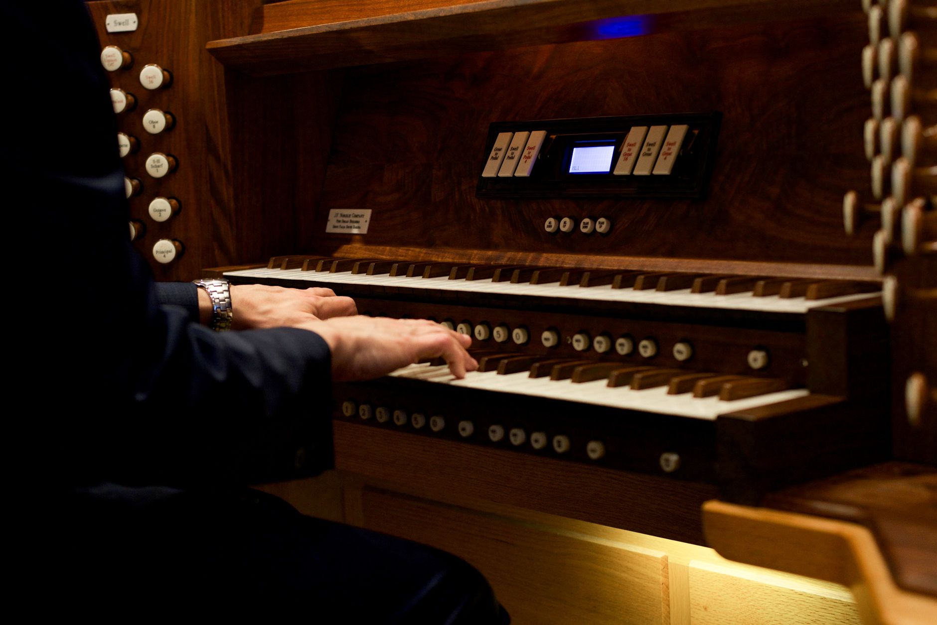 close up of a person playing the organ
