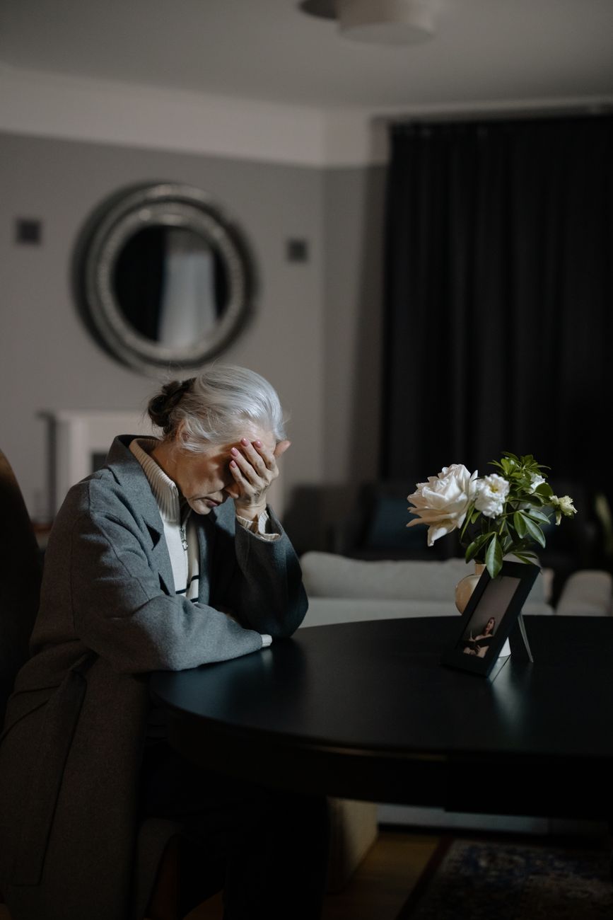 an elderly woman grieving